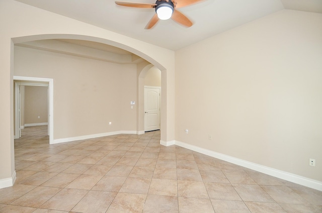 tiled empty room featuring ceiling fan and lofted ceiling