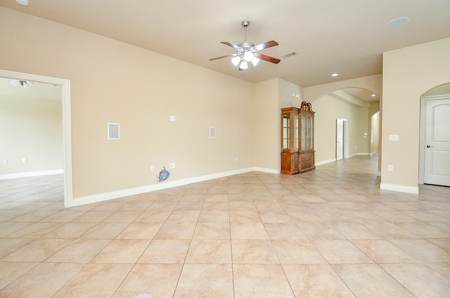 tiled spare room featuring ceiling fan