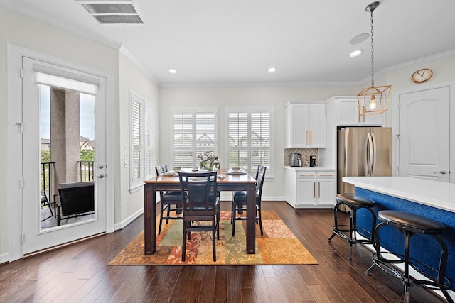 10812 Kyler Oaks Pl, Houston, TX 77043 - dining space with healthy amount of natural light, dark wood-style flooring, crown molding, recessed lighting, and baseboards