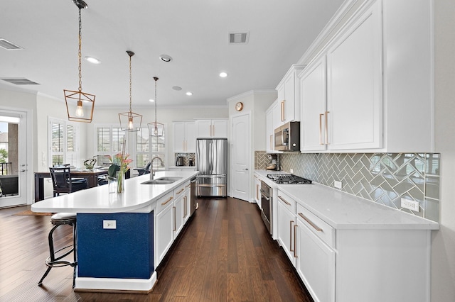 10812 Kyler Oaks Pl, Houston, TX 77043 - kitchen featuring stainless steel appliances, a sink, white cabinets, recessed lighting, and backsplash