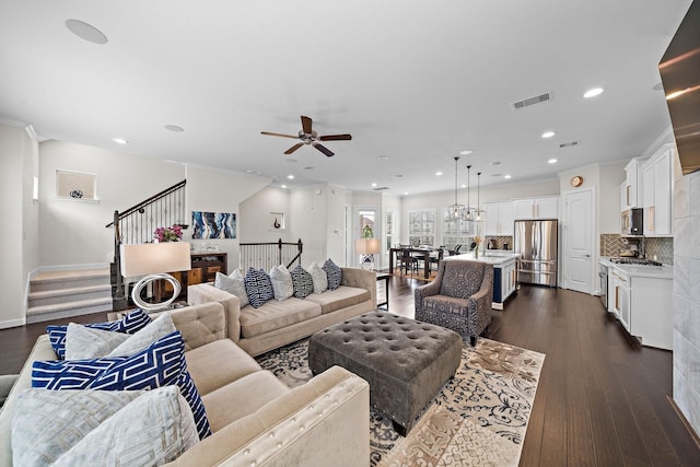10812 Kyler Oaks Pl, Houston, TX 77043 - living room with stairway, recessed lighting, ceiling fan, dark wood-type flooring, and crown molding