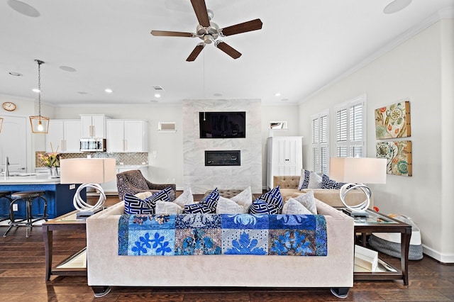 10812 Kyler Oaks Pl, Houston, TX 77043 - living area with ornamental molding, a ceiling fan, a fireplace, dark wood-style floors, and baseboards