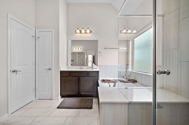 10812 Kyler Oaks Pl, Houston, TX 77043 - bathroom with vanity, a tub to relax in, vaulted ceiling, and marble finish floors