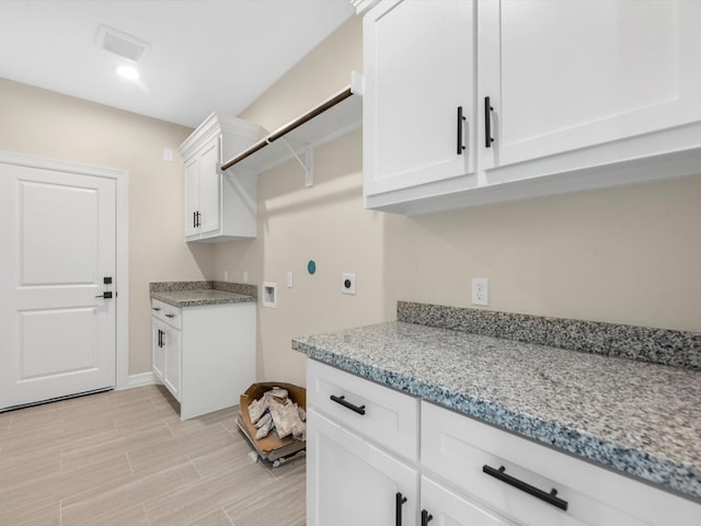 clothes washing area featuring cabinets, washer hookup, and hookup for an electric dryer