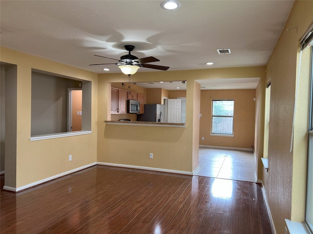 unfurnished living room with ceiling fan and light hardwood / wood-style floors