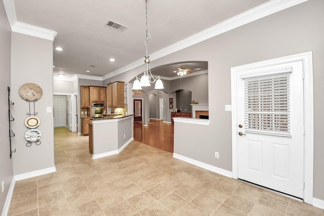 kitchen featuring ornamental molding, stainless steel oven, and kitchen peninsula