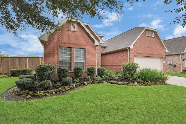 traditional home with fence, a front lawn, concrete driveway, a garage, and brick siding