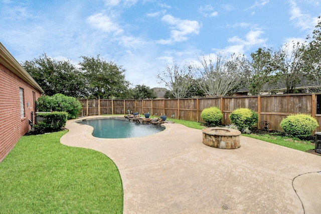 view of pool featuring a patio, a yard, and an outdoor fire pit