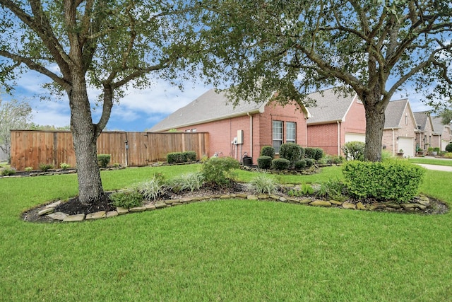 view of yard with a garage and fence