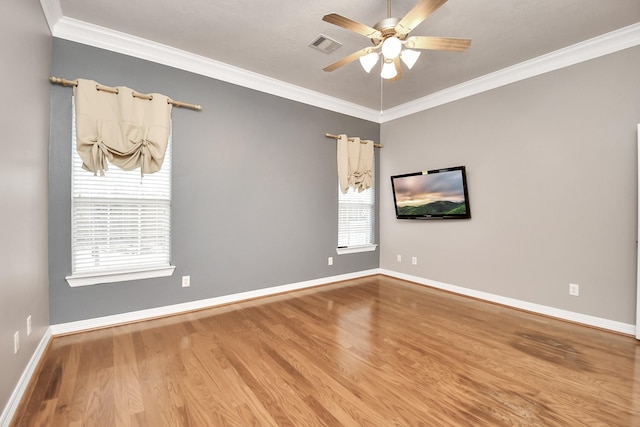 spare room featuring hardwood / wood-style flooring, plenty of natural light, ornamental molding, and ceiling fan