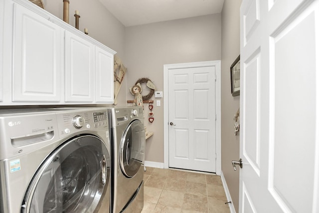 laundry room featuring washer and dryer, baseboards, and cabinet space