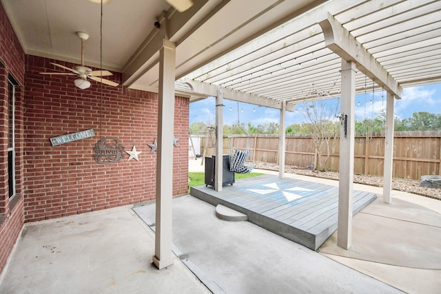 view of patio with a deck, ceiling fan, and a pergola