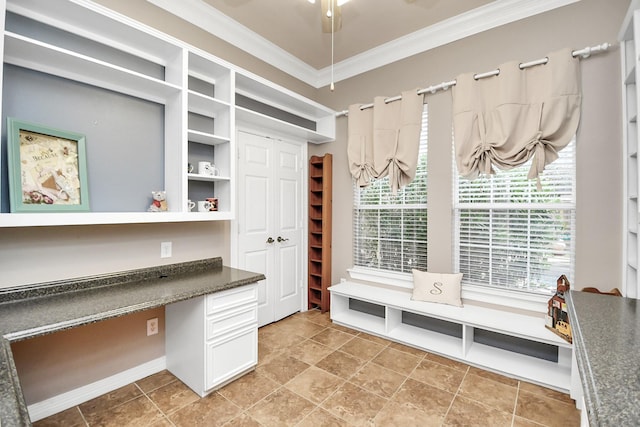 mudroom featuring ornamental molding and built in desk