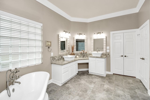 full bathroom with a freestanding tub, baseboards, vanity, and crown molding