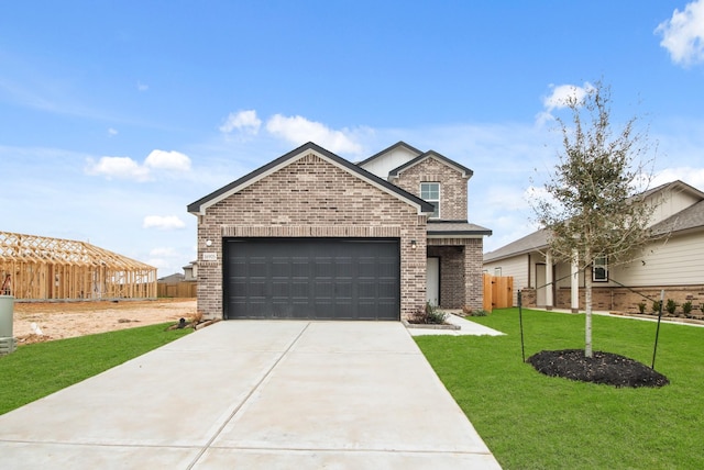 view of front of house with a garage and a front yard