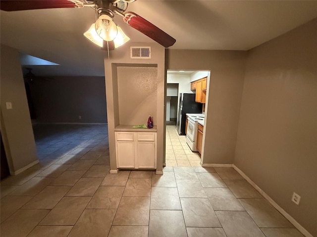 kitchen featuring white range with electric stovetop, light countertops, visible vents, a ceiling fan, and baseboards