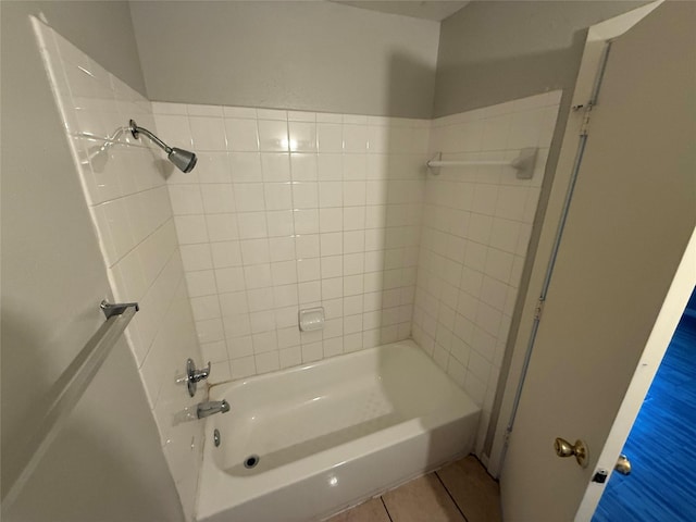 bathroom featuring tiled shower / bath combo and tile patterned flooring