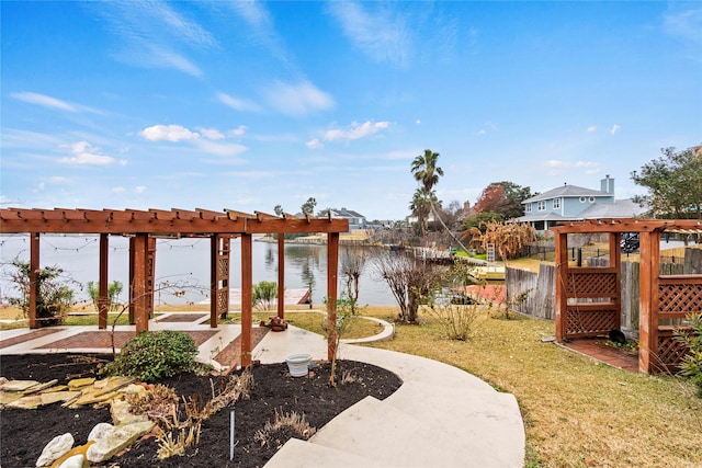 view of yard featuring a water view and a pergola