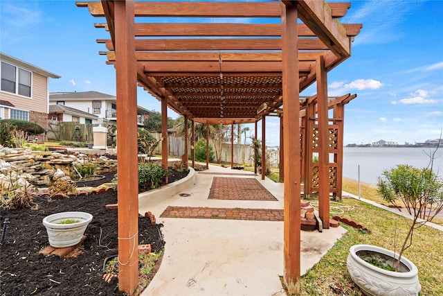 view of patio / terrace featuring a pergola and a water view