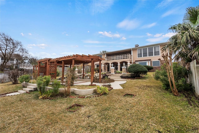 back of house featuring a pergola and a lawn