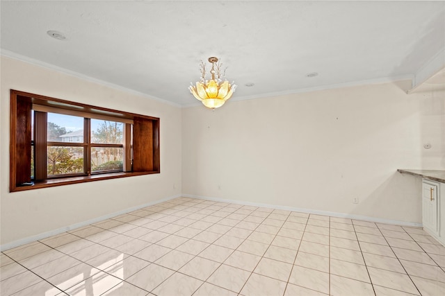 unfurnished room with ornamental molding and light tile patterned floors