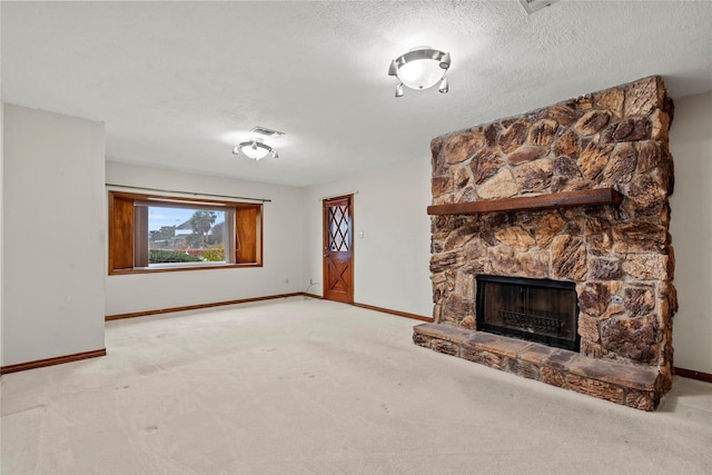 unfurnished living room featuring light colored carpet, a fireplace, and a textured ceiling