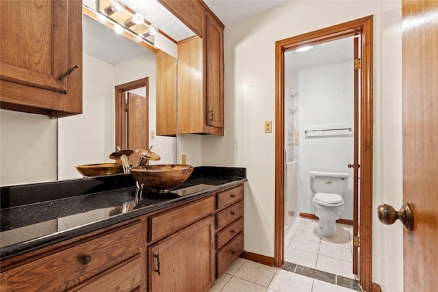 bathroom featuring tile patterned flooring, vanity, and toilet