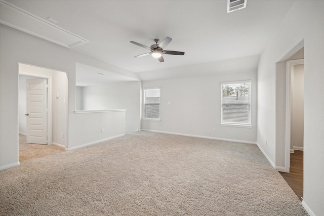 spare room featuring light colored carpet and ceiling fan