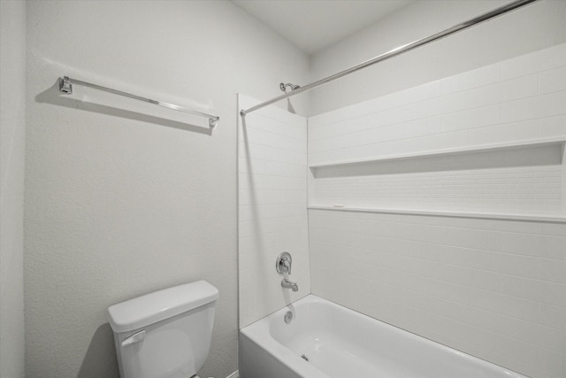bathroom featuring tiled shower / bath and toilet