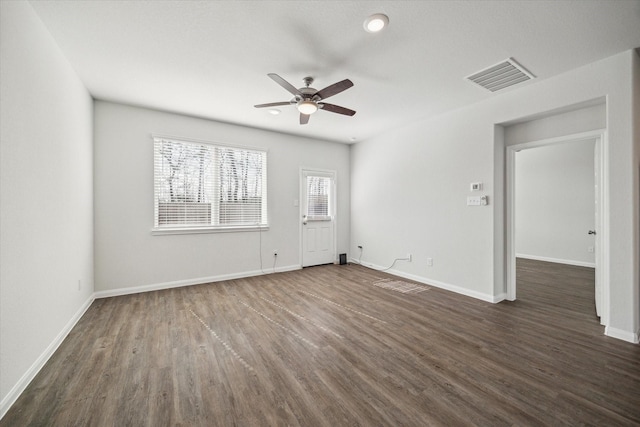 empty room with dark hardwood / wood-style floors and ceiling fan