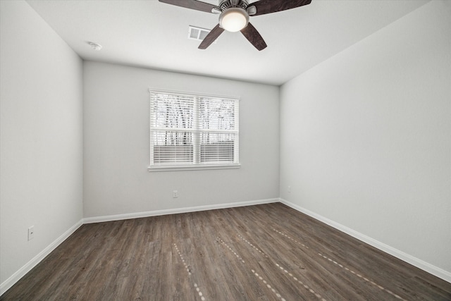 spare room featuring dark wood-type flooring and ceiling fan