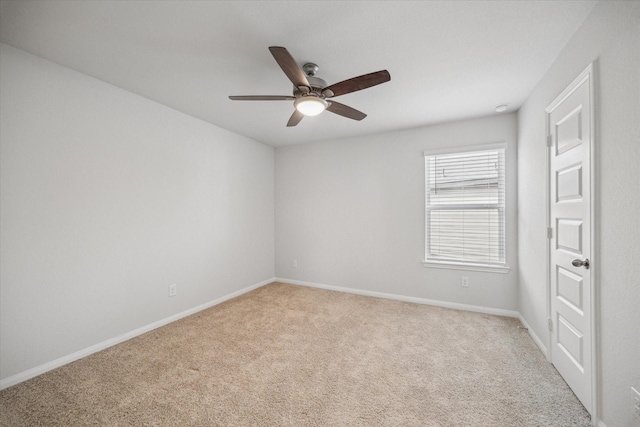 unfurnished room with ceiling fan and light colored carpet