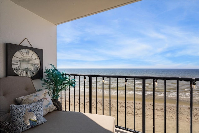 balcony featuring a water view and a view of the beach