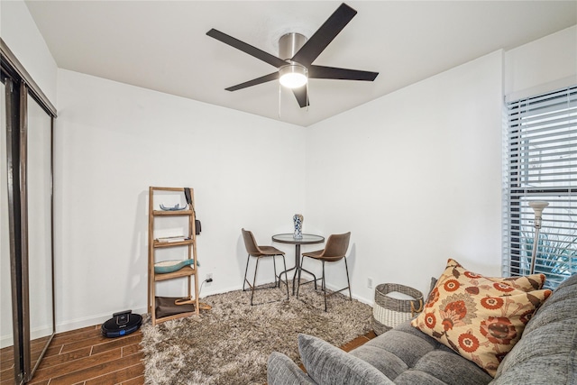 sitting room with ceiling fan and dark hardwood / wood-style floors