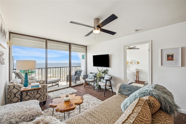 living room featuring hardwood / wood-style flooring, expansive windows, and ceiling fan