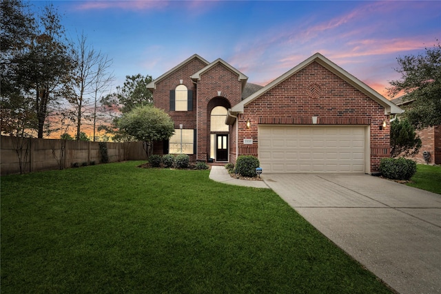 view of front property with a garage and a lawn