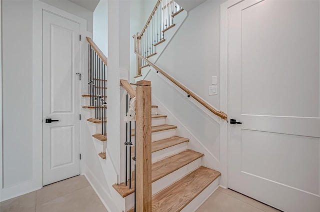 staircase with tile patterned floors