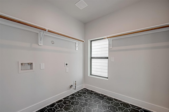 clothes washing area with hookup for a gas dryer, hookup for a washing machine, and electric dryer hookup