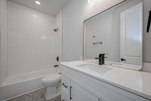 full bathroom with tiled shower / bath combo, vanity, and toilet