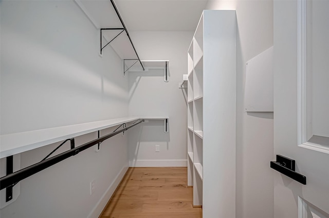 spacious closet with light hardwood / wood-style flooring