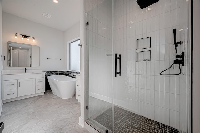 bathroom featuring vanity, separate shower and tub, and tile walls