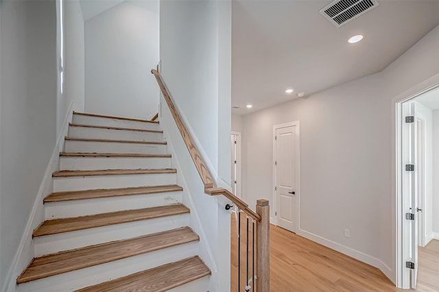 stairway featuring recessed lighting, visible vents, baseboards, and wood finished floors