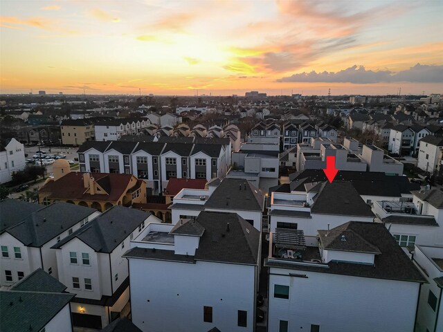 aerial view at dusk featuring a residential view