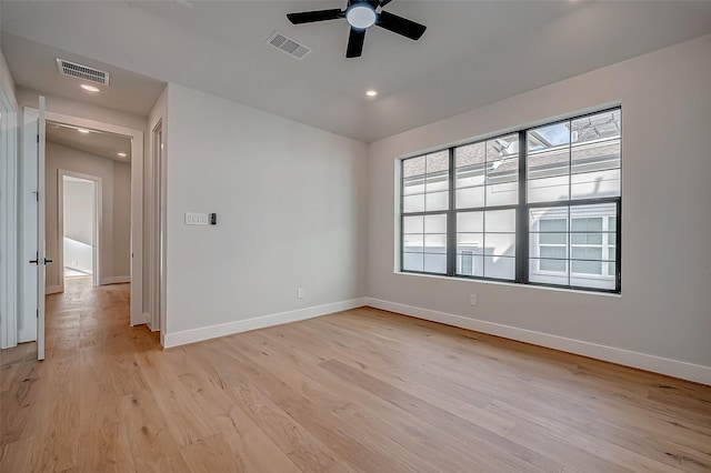 spare room featuring ceiling fan and light hardwood / wood-style floors