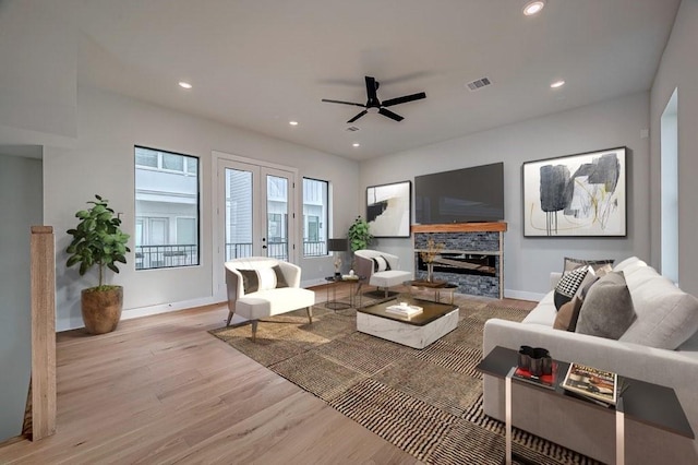 living area with french doors, recessed lighting, visible vents, light wood-style flooring, and baseboards