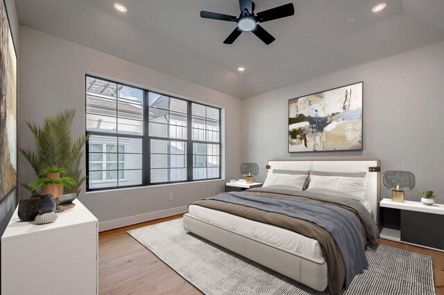 bedroom with multiple windows, recessed lighting, and light wood-style floors