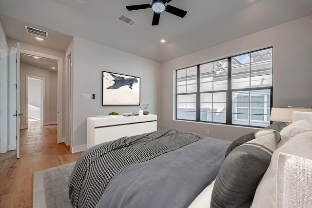 bedroom with light wood finished floors, multiple windows, and visible vents