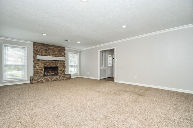 unfurnished living room featuring baseboards, carpet floors, a textured ceiling, and crown molding