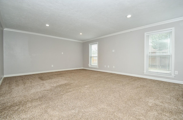 carpeted spare room with baseboards, a textured ceiling, recessed lighting, and crown molding