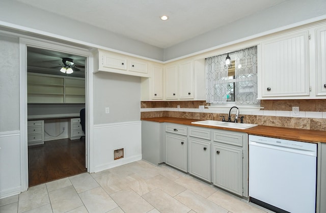 kitchen with a sink, butcher block counters, dishwasher, and light tile patterned flooring